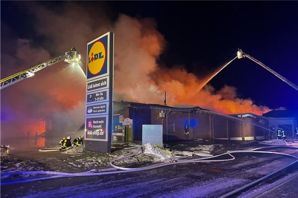 Die Feuerwehr bekämpft von Drehleitern aus den Brand in einem Lidl Supermarkt. 