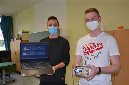 Malte Harms (links) zeigt auf seinem Laptop, wie die Analyse-Software für die CO2-Messgeräte aussieht. Nils Onnen präsentiert das zweite, verbesserte Messgerät.