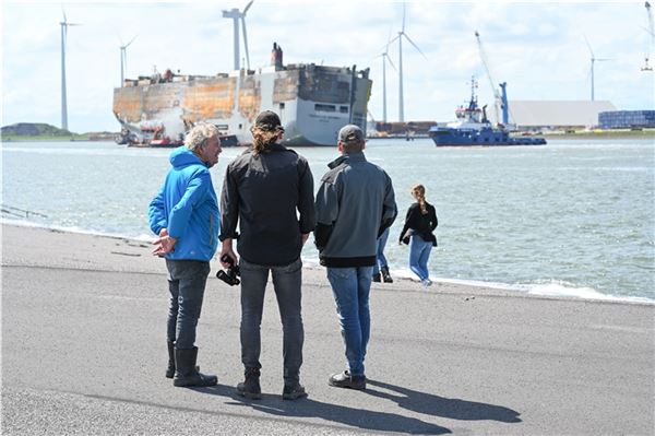 dpatopbilder - 03.08.2023, Niederlande, Eemshaven: Männer beobachten im Hafen de...