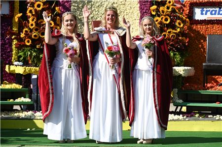  Das frisch gekrönte „Königshaus“ winkt auf der Bühne: Erste Blütenprinzessin Joey Melina Folkerts, Blütenkönigin Clematis I. Meike Deharde und zweite. Blütenprinzessin Antje Kopietz.