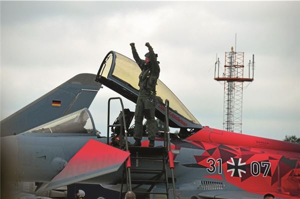 „Back Again“: Die Eurofighter sind wieder zurück in Wittmund Feierlich steigt Kommodore Björn Andersen aus dem sonderfolierten Flieger aus.