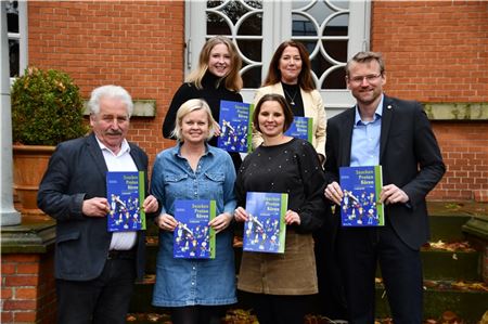 Landschaftspräsident Rico Mecklenburg, Anja Enninga, Lehrerin an der Hermann Tempel Gesamtschule IGS Ihlow und Fachberaterin für die Region und die Sprachen Niederdeutsch und Saterfriesisch im Unterricht beim Regionalen Landesamt für Schule und Bildung Osnabrück, Grietje Kammler, Leiterin des Plattdüütskbüros, Imke Schöneboom, Fachberaterin für die Region und die Sprachen Niederdeutsch und Saterfriesisch im Unterricht beim Regionalen Landesamt für Schule und Bildung Osnabrück, Evelyn de Vries, Schulfachliche Dezernentin beim Regionalen Landesamt für Schule und Bildung Osnabrück, sowie Landschaftsdirektor Dr. Matthias Stenger bei der Vorstellung der Neuauflage des Lehrbuchs „Snacken. Proten. Kören.“ Foto: Ostfriesische Landschaft