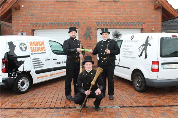 Michael Ihmels (rechts) hat den symbolischen Staffelstab an Jendrik Seeberg (links) weitergereicht. Ab Januar 2026 ist Seeberg gemeinsam mit seinem Mitarbeiter Marten Friedrichs (Mitte) für den Kehrbezirk im Bereich Holtriem und Tannenhausen verantwortlich. Foto: privat