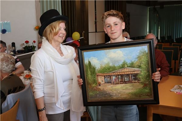 Simon Kracke ersteigerte das Ölgemälde – Eva Schmidt-Ewert, Tochter des Künstlers Günter Seekatz, leitete die Versteigerung. Foto: Irmi Hartmann