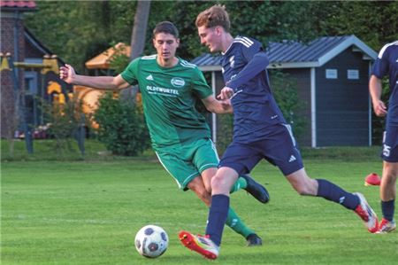 Trotz früher Führung am Ende klar verloren. Hauke Hollwege (blau) und der SV Hage II mussten ein Gegentor des ehemaligen Vereinskollegen Timo Sabath (grün) schlucken. Foto: Hinrich Saathoff